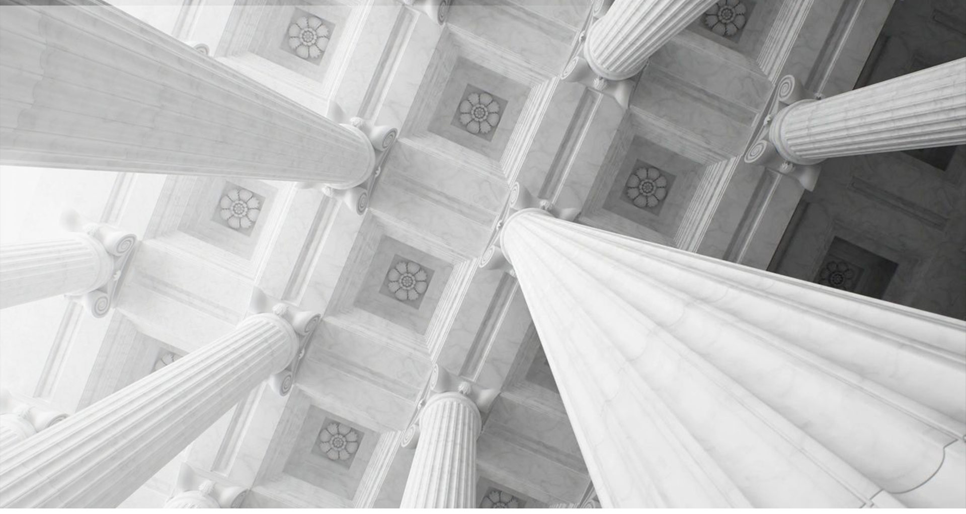 A white building with columns and a ceiling.